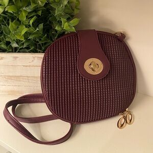 Purple Semi Round Faux Leather Crossbody Purse with Gold Accents.